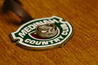 Medinah Country Club logo underneath a wedding ring