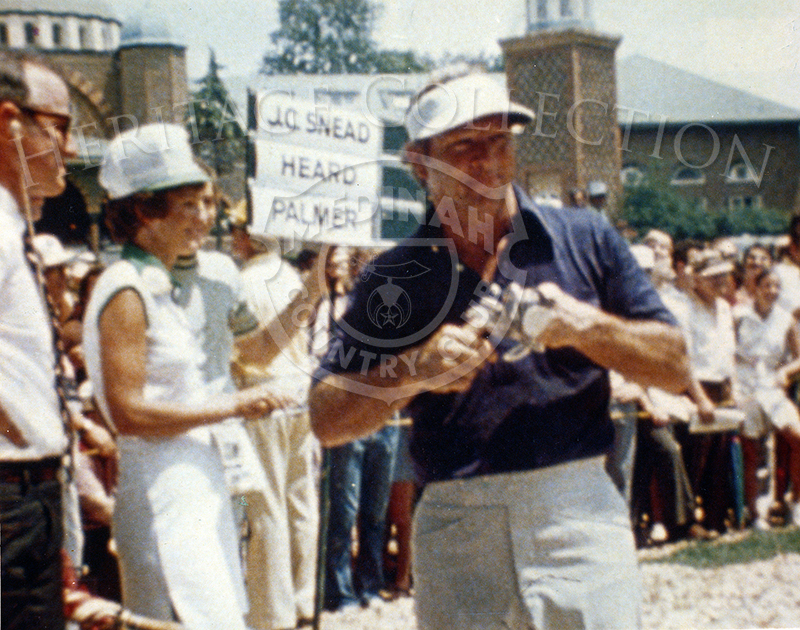 A still frame off a 16mm movie film captures Arnold Palmer preparing for the 75th U.S. Open. The sign directly behind him shows he was grouped with Jesse Carlyle 