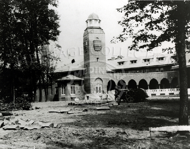 West side view of Medinah Country Club clubhouse under construction with tractor in front.