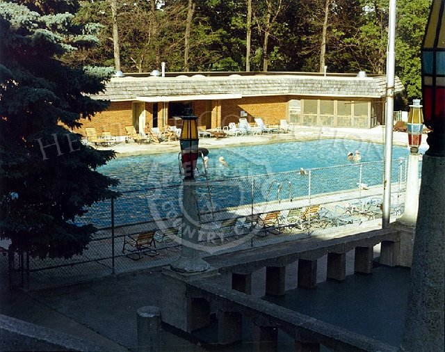 Swimming pool seen from top side with 4 swimmers.