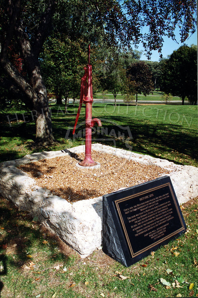 Historic site showing water pump and well.