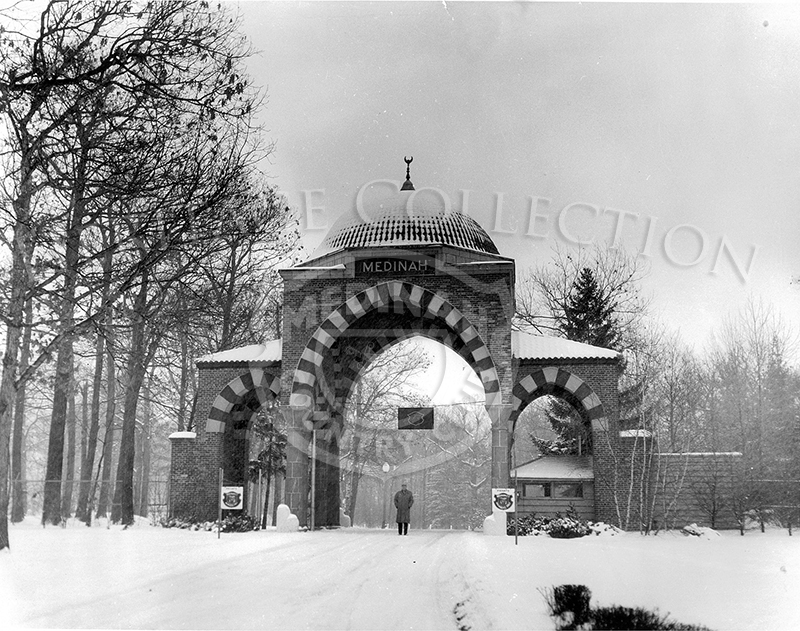 Snow scene of entrance to MCC. Man standing in entrance.