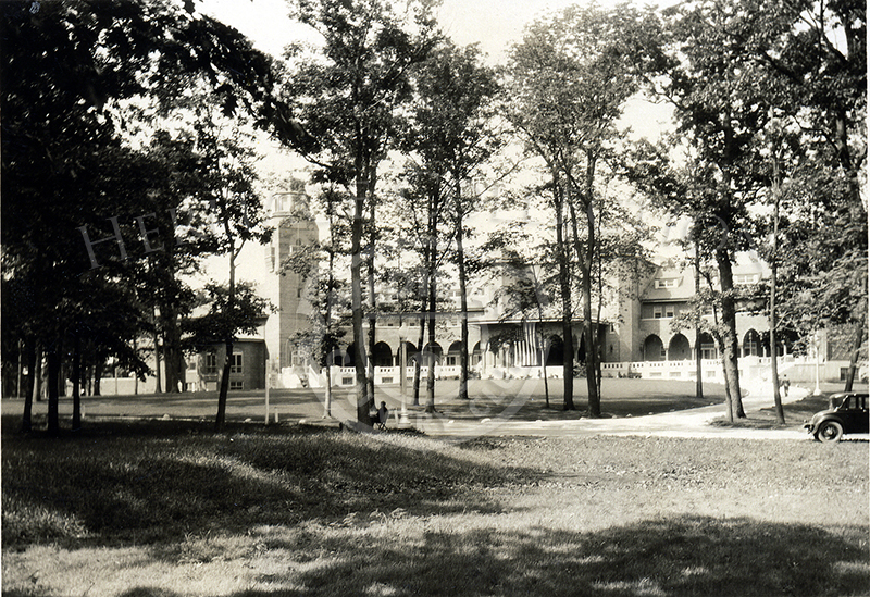 View of clubhouse through the trees.