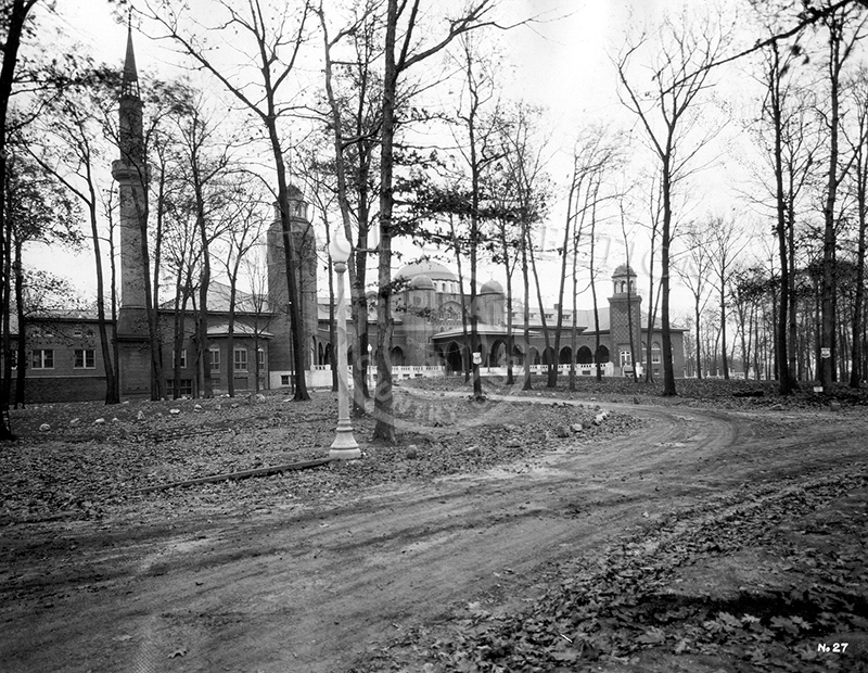 Club House front seen through trees, circa 1920s.