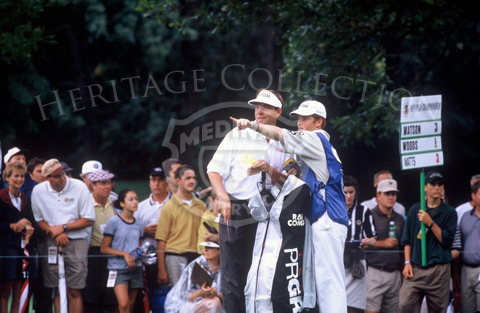 Brian Watts and caddy discuss the layout of one of the fairways on Course No. 3, during Round 2 of the 81st PGA. As indicated by the sign in the background, Watts was grouped with Tom Watson and Tiger Woods.
