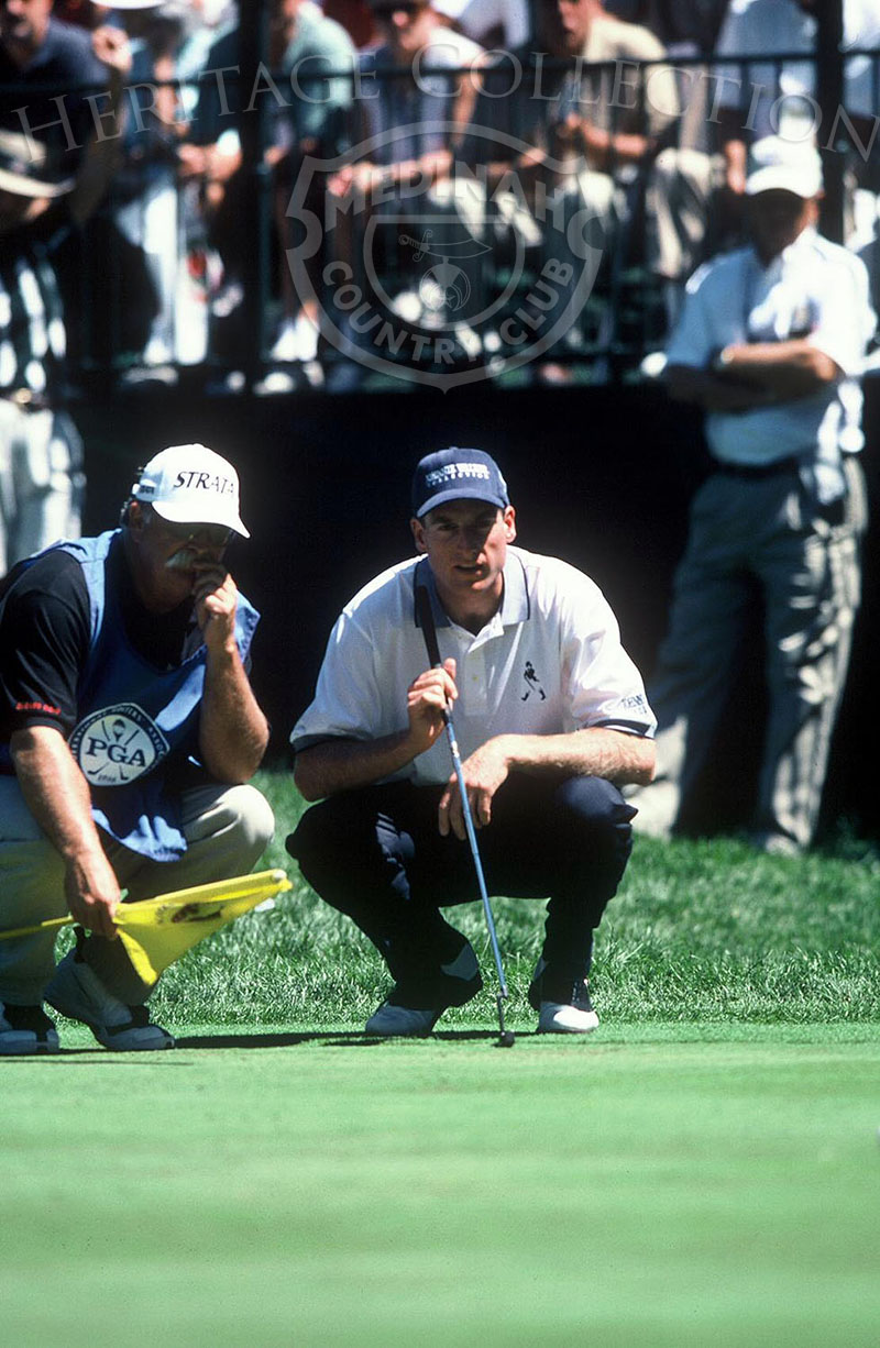 Contemplating his next putt, Jim Furyk discusses the situation with his caddy during the 81st PGA championship. He finished the tournament tied with Steve Pate for 8th-place. Both men scored a 284, which was 4 under par.