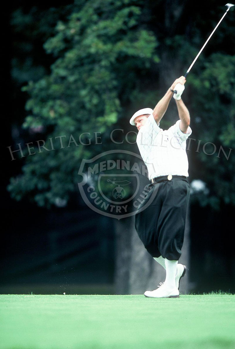Payne Stewart, outfitted in his signature plus-fours (knickers) pants and peaked cap, sends a ball flying down one of the fairways on Course #3 during the 81st PGA championship. This was not one of his better performances, finishing the tournament at 295.