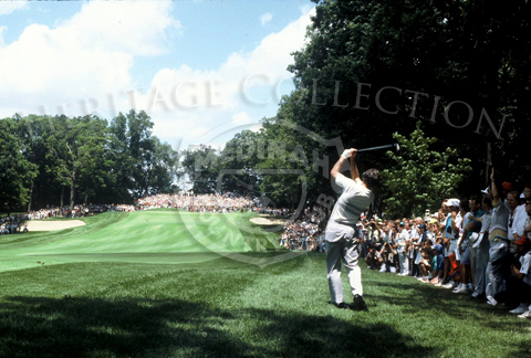 This scene captured the large gallery of people who attended the 18-hole playoff round on August 18, 1990, during the 90th U.S. Open Championship. All eyes were on Hale Irwin as he drives the ball down one of the fairways. Hale won over challenger Mike Donald, and became the oldest U.S. Open Champion and the fifth man to win the title more than twice.