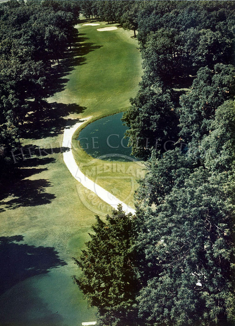 1975 Aerial view of the 421-yard Hole 3 of Course No. 3. It requires a carefully placed drive on the right half of the fairway to open up the green hidden behind a forest of oaks.