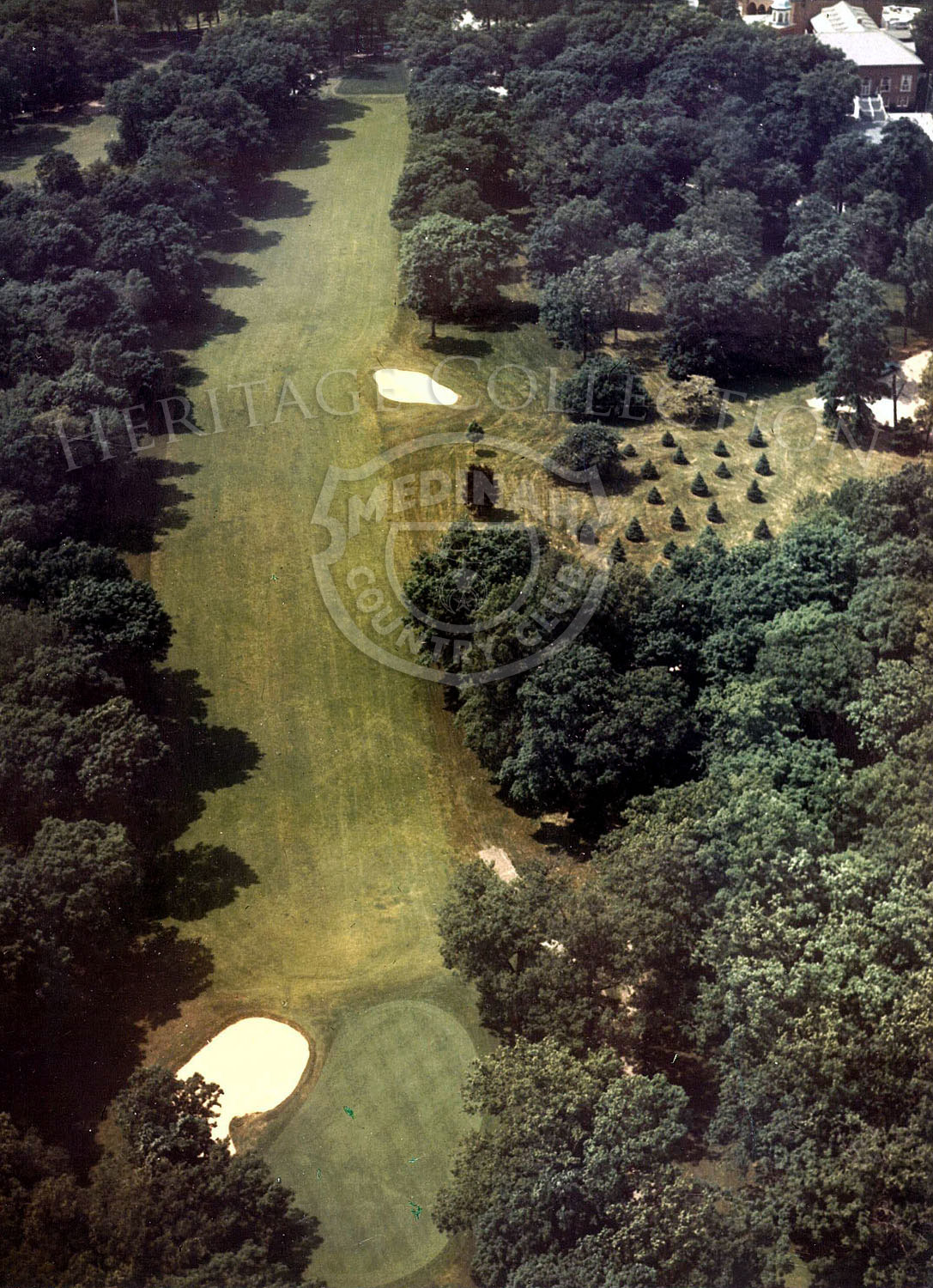 1975 Aerial view of Hole 1 of Course No. 3. The relatively short 390-yard par-4 first hole is indicative of what's to follow: tree-lined fairway and fast, titled green. Also see 85174.