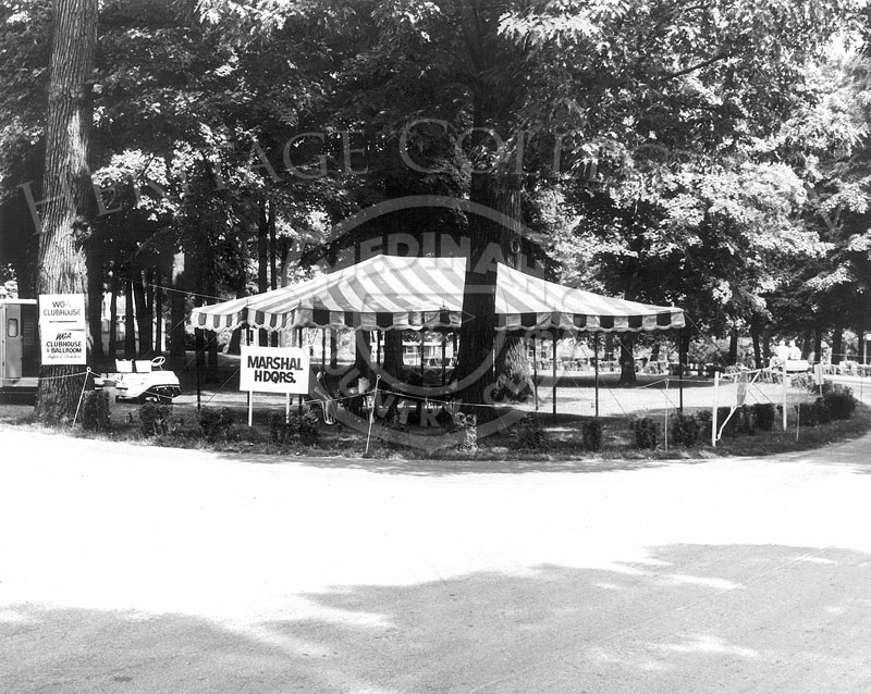 An open air tent was used as Marshal Headquarters during the 63rd Western Open tournament in 1966, held at Medinah Country Club. Signs on the far left point where to go for the WGA Clubhouse & Ballroom buffet and cocktails.