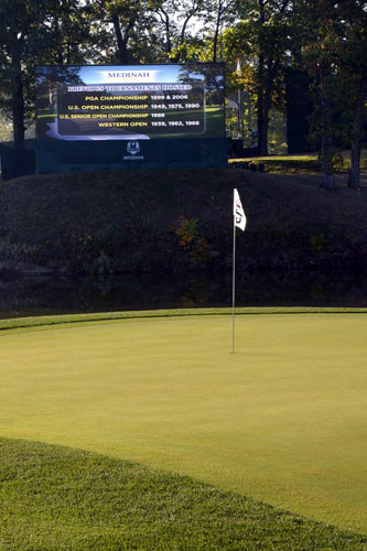 Scene of 17th green before matches on Sunday morning. The jumbotron displays all the major tournaments held at Medinah.