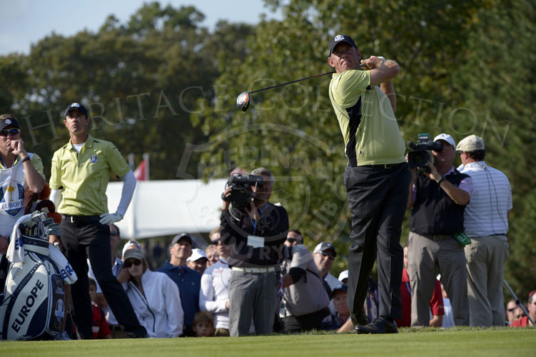 Westwood hits his tee shot on the par 4 9th hole during Friday's matches, partner Colsaerts looks on.