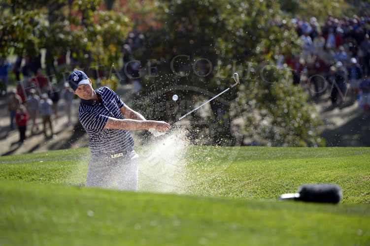 Webb Simpson blasts out of the bunker during the Saturday matches.