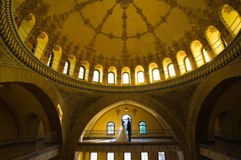 A bride and groom on the balcony inside the Medinah Clubhouse